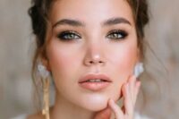 41 a delicate wedding makeup with a nude lip, a touch of blush, smokey eyes, brushed eyebrows and a touch of highlighter