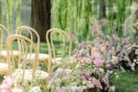 41 an outdoor wedding ceremony space with lilac, blush and yellow blooms and greenery is amazing for spring