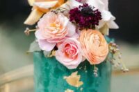 42 an emerald textural wedding cake with gold foil, with orange, blush and white blooms and purple ones for a bolder touch
