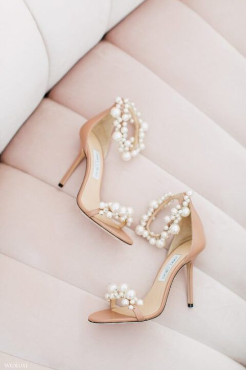 nude wedding shoes with high heels and lots of pearls of various sizes are amazing for a wedding