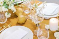 43 a marigold and white wedding tablescape with a bold tablecloth, blooms and pears right on the table