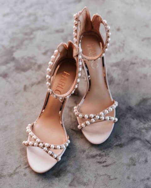 nude wedding shoes with pearl detailing and criss cross straps are a chic and glam idea for a wedding