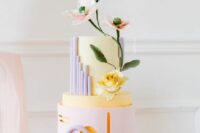 44 a catchy pastel spring wedding cake with a blush and yellow tier, lilac details and some goemetry plus sugar blooms