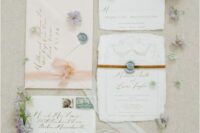 44 a neutral wedding invitation suite with a blush envelope, gold calligraphy and irregular-shaped pieces, white fabric ribbon