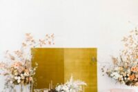 45 a mustard fabric backdrop surrounded with lush florals is a fantastic idea for a refined wedding