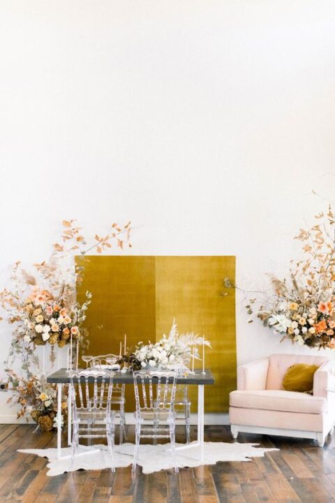 a mustard fabric backdrop surrounded with lush florals is a fantastic idea for a refined wedding
