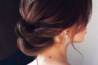46 a super elegant low twisted updo with a bump and some locks down is a gorgeous idea for a refined bride
