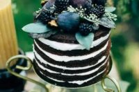 47 a naked chocolate wedding cake topped with fresh fruit and berries, with greenery is a fantastic and yummy-looking idea for a fall wedding