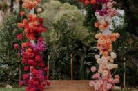 48 a colorful floral wedding arch with blooms of hot pink and light pink, red, orange, white, peachy pink colors looks spectacular