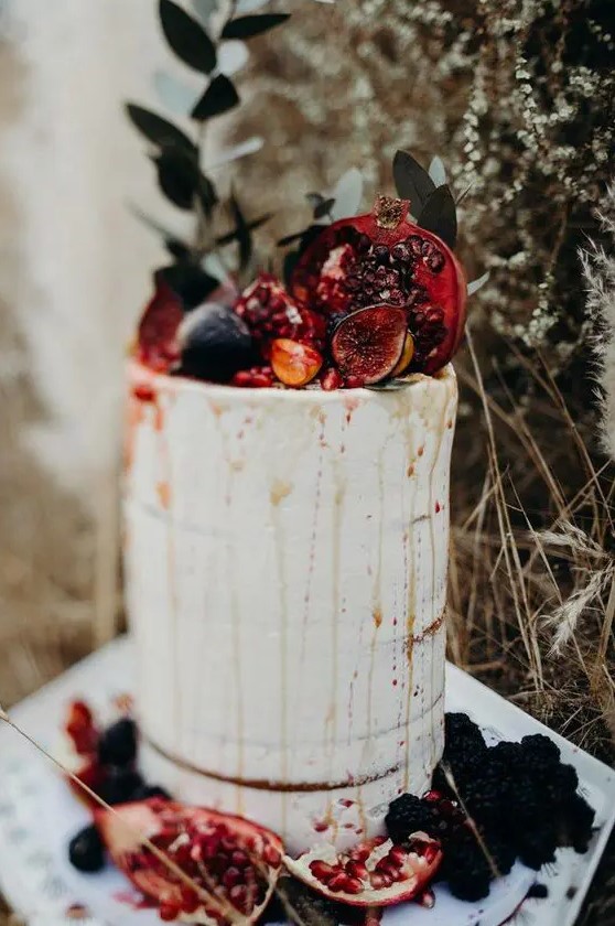 a naked fall wedding cake with drip, fresh figs and pomegranates is a lovely decadent idea for a fall celebration
