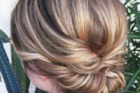 48 a twisted low updo with a sleek bump is an elegant and chic hairstyle for a bride or bridesmaid
