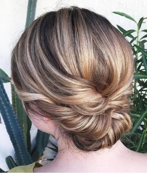 a twisted low updo with a sleek bump is an elegant and chic hairstyle for a bride or bridesmaid