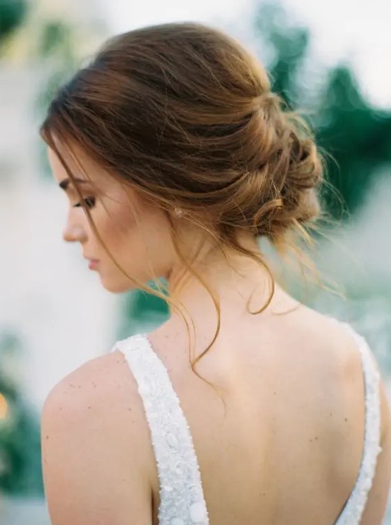 a very chic wavy low updo with a volume on top and some locks down is a great option for many bridal looks