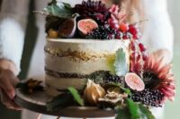 50 a naked wedding cake with a gold touch, with lots of fresh fruit and berries and dark blooms on top is a gorgeous idea for a fall wedding