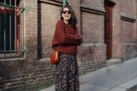 51 a pretty and casual fall wedding look with a burgundy oversized sweater, a navy midi skirt with colorful floral prints, purple booties and an amber bag
