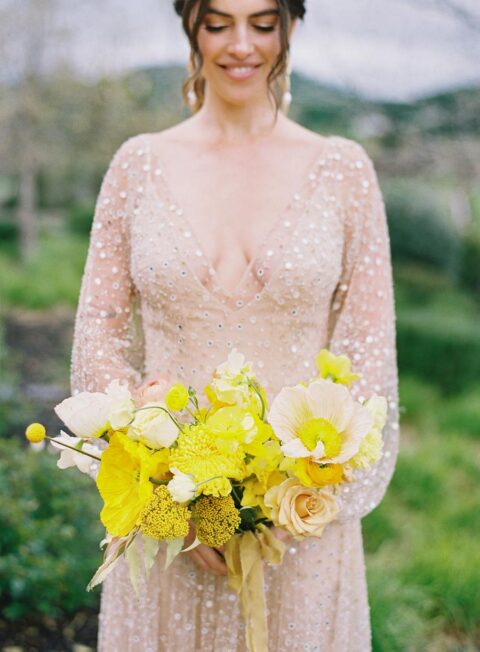 a super bold yellow wedding bouquet with various blooms and with billy balls is a real color statement