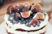 52 a naked wedding cake with fresh figs and blueberries on top is a cool idea for a summer or fall wedding