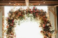 53 a gorgeous rustic fall wedding arch done with lots of greenery, pampas grass, blush, deep red, burgundy blooms and candle lanterns