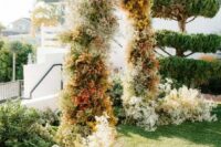 54 a lovely and creative baby’s breath wedding arch spray painted in various colors, with additional blooms on both sides