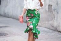 54 a white blouse with accented shoulders, a green flare floral skirt, nude strappy heels and a pink clutch