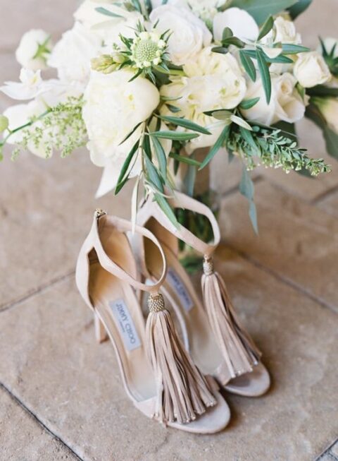 nude wedding shoes with ankle straps and oversized tassles are amazing for rocking them at your wedding with a boho feel