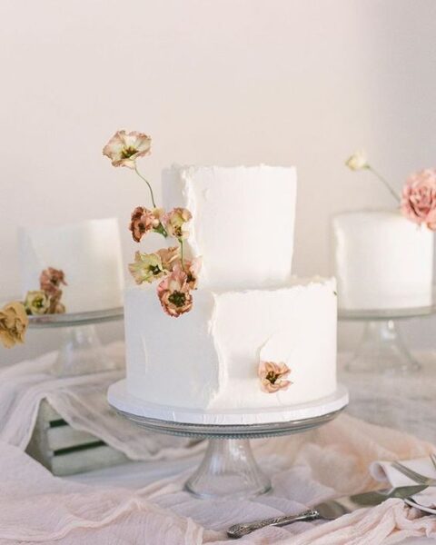 a white wedding cake with plenty of texture and a raw edge, dried blooms are amazing for a lovely summer wedding