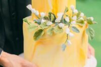 60 a yellow marble wedding cake with blooms and greenery is a bright and elegant idea for spring or summer