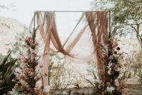 62 a beautiful and breezy wedding backdrop with blush drapes, pink and white blooms and branches on both sides of the arch