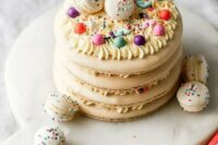 67 a neutral macaron cake topped with colorful beads and macarons with colorful sprinkles is a lovely idea for a spring or summer wedding
