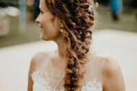 a beautiful thick braid composed of several braids and with small blooms tucked into the hairstyle is a very cool idea