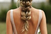 a beautiful twisted braid with a double twisted halo and a floral headpiece is a cool idea for a boho bride