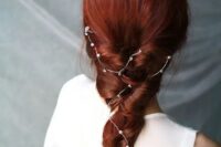 a bold red braid with a constellation crystal hair vine is a cool idea for a celestial or boho bride