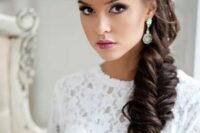 a chunky loose fishtail braid with a volume on top is a fantastic idea for a bride with long and thick hair