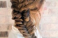a fishtail braid of two parts and some loose hair for a casual and relaxed look