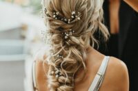 a gorgeous loose and messy twisted braid with a couple of braided halos and baby’s breath tucked into the braid