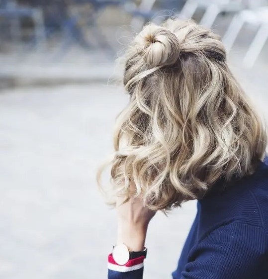 a half updo with a bun and waves can be made in a couple of minutes and looks textural