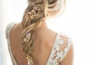 a messy and loose twisted braid with a beaded floral hair vine to accent it and give a more refined and chic look