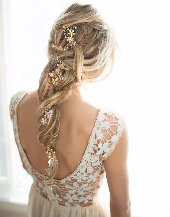 a messy and loose twisted braid with a beaded floral hair vine to accent it and give a more refined and chic look