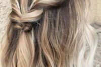 a pretty brown medium length half up hairstyle with blonde balayage, a twisted and braided top plus waves