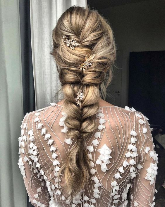 a pretty losse classic braid with woven top and back of your head plus floral hairpieces is amazing for a wedding
