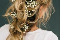 a romantic tousled bridal braid adorned with baby’s breath looks ethereal and will be perfect for a boho bride