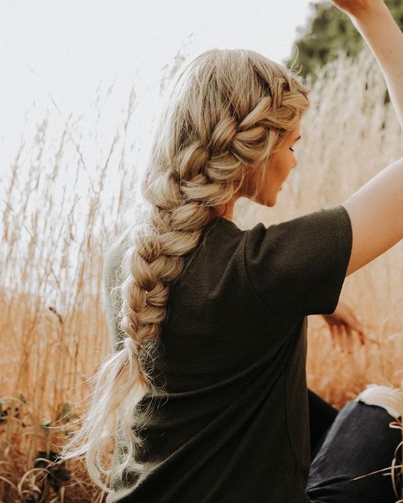 a thick blonde braid coming from one side of your head, with no detailing is a gorgeous idea for a boho bride