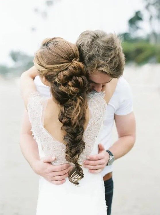 a twisted braid with a lot of volume and a lot of twisted touches is a cool idea for a bride with thick and long hair