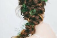 a twisted braid with greenery tucked in instead of flowers is a fantastic idea for a woodland bride