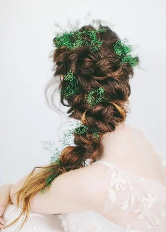 a twisted braid with greenery tucked in instead of flowers is a fantastic idea for a woodland bride