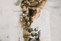 a very dimensional and textural braid made of two side ones with fresh flowers