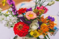 an eclectic wedding centerpiece of a vintage teapot and super bright blooms and greenery is amazing for a bold vintage wedding