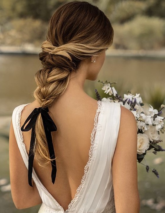 an elegant twisted braid with wavy ends and a black ribbon for an accent - it's a hot and trendy idea