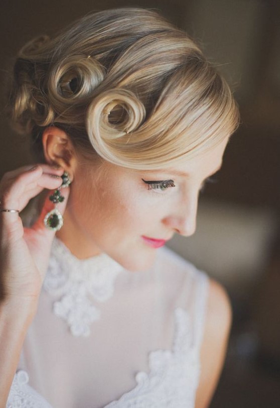 an updo with fixed curls on medium length hair and a curled side bang is a cool idea