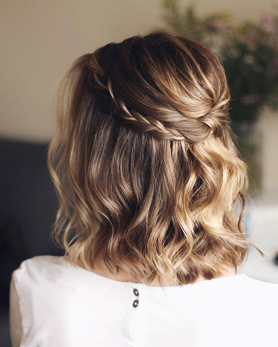 a light brown long bob with golde blonde balayage, waves and a braided halo is a chic and stylish idea for a wedding